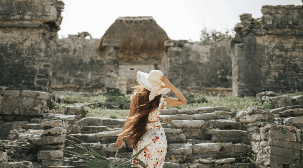 A woman on vacation exploring ruins. 