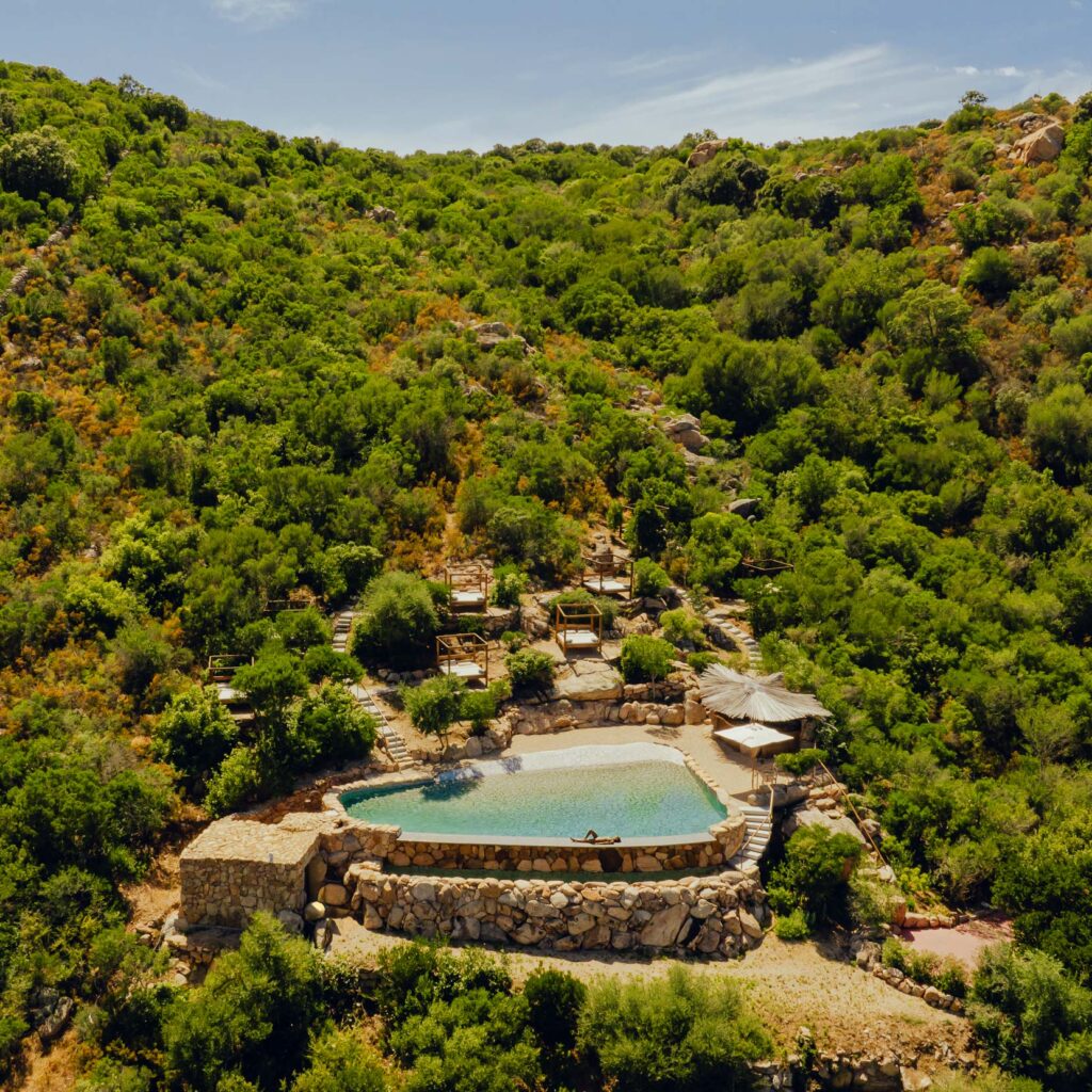 A hotel pool in Sardinia, featured on Tablet Hotels, an AirBnB alternative.