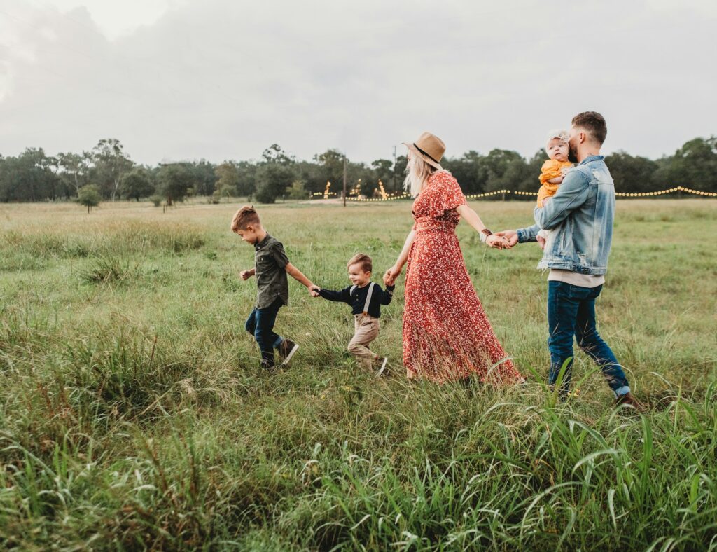 A family enjoying a walk in a field.