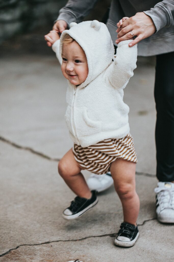 A toddler taking their first steps.